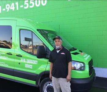 a man standing in front of green van