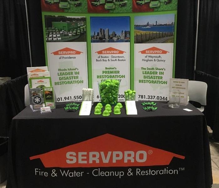 a SERVPRO booth with green rubber ducks on it